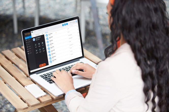 A remote employee types on her laptop.