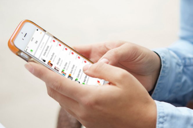 A close-up of a person's hands, using a smartphone.