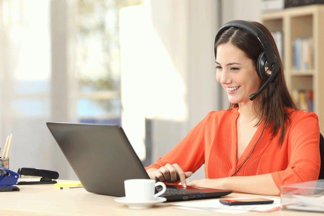 A woman sits in a home office on a video call.