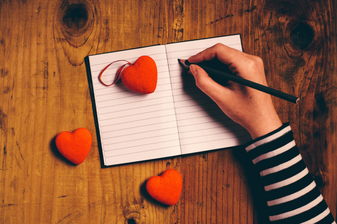 A woman writes a love letter.