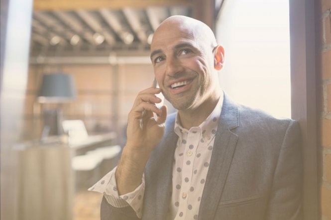 A man in a suit talking on a mobile phone