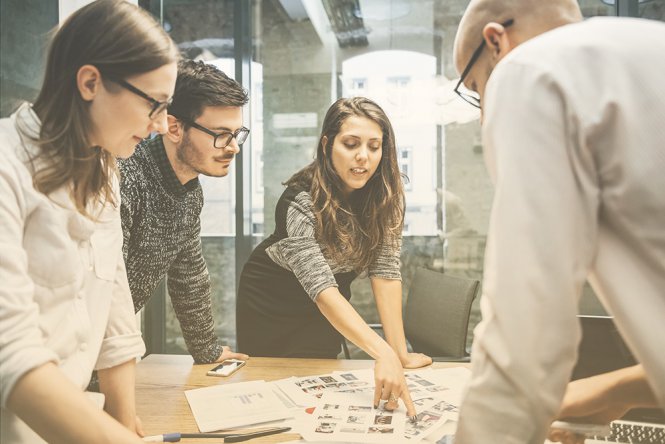 A group of people collaborate on a project in an office.