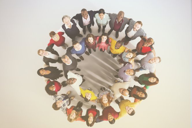 An overhead view of employees connected in a circle, representing enterprise cloud solutions.