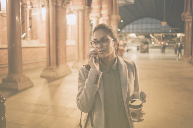 A woman talking on her mobile phone, thanks to advances for telecommunications in business.