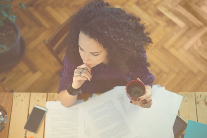A woman sitting at her desk, using the best video conferencing for small businesses.