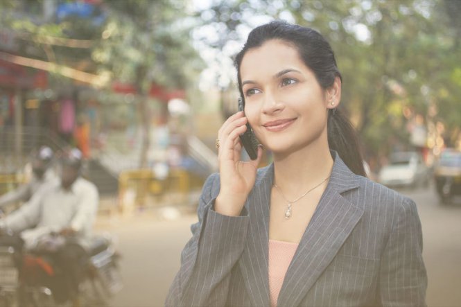 A real estate agent on her smartphone, streamlining business processes.