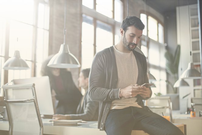 A man having difficulty using an app because of poor network signal strength.