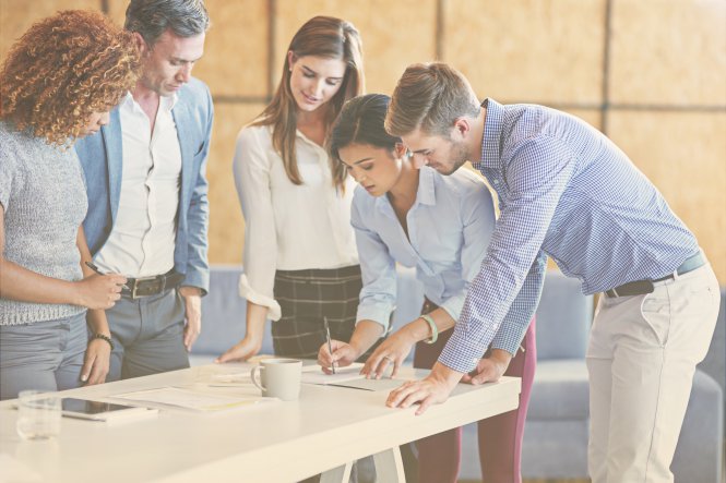 A group of co-workers using cross-team collaboration to fix a problem.