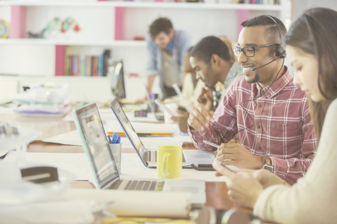 People in an office using APIs in business to provide better customer experiences.