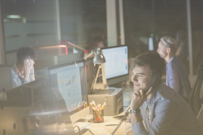 A man using his office phone thanks to the SIP definition: flexibility and scale.