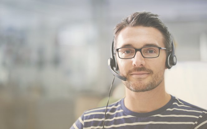 A sales team member on a headset, representing the impact of technology on business communication.