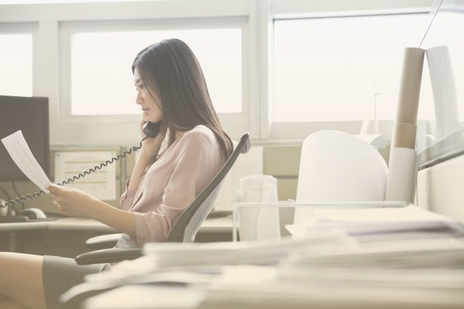 A woman making business phone calls.