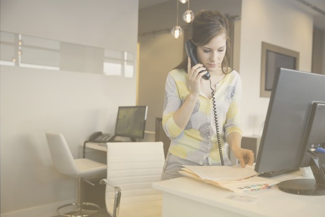 How does SIP trunking work? A woman uses her office phone to call another branch.