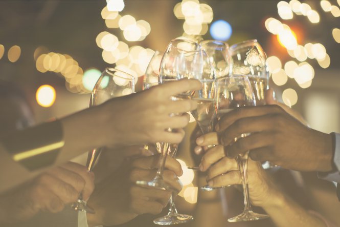 Co-workers celebrate UCaaS solutions and the holidays with champagne.