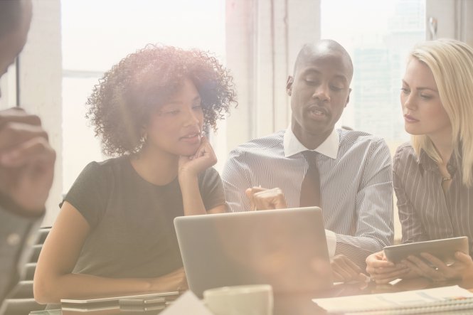 Co-workers discuss the benefits of modern business communication.