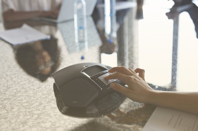 A speakerphone is used to dial a call and contact center.