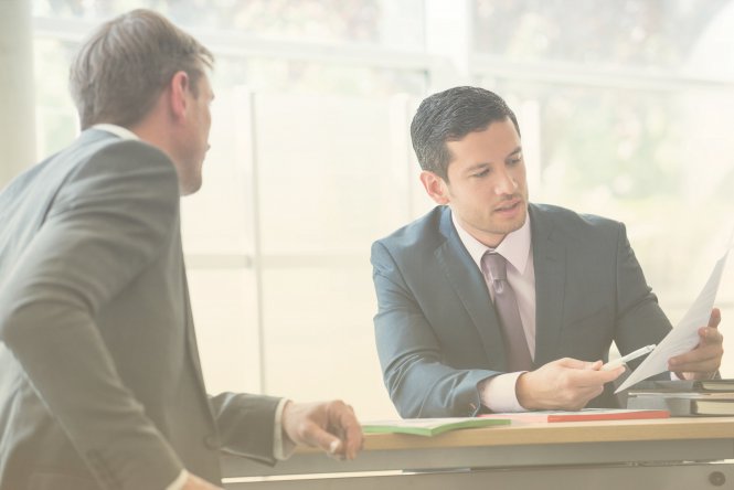 A finance professional explains the benefits of SD-WAN technology to a colleague.
