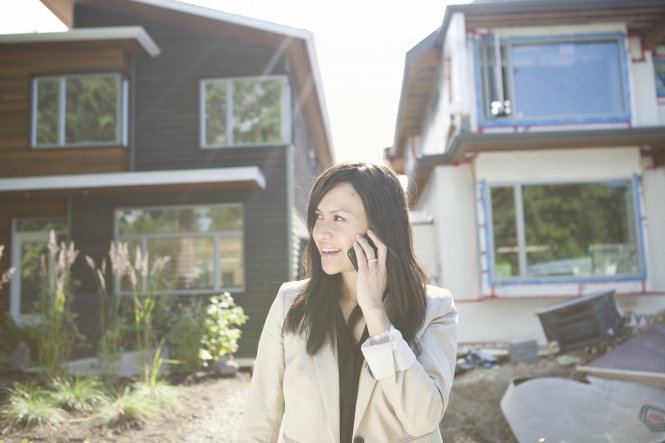 A woman engaging with a real estate chatbot on her phone.