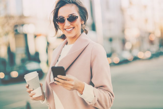 A woman uses two-way text messaging on her smartphone to contact her credit union