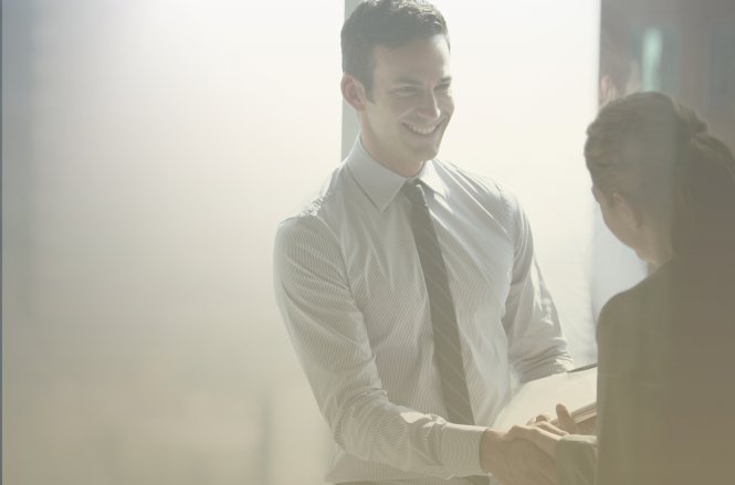 A lawyer shakes hands with a client who has interacted with a virtual receptionist for lawyers