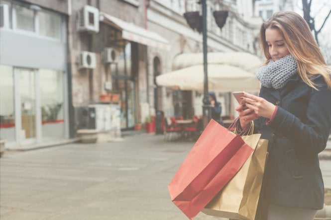 Woman using her smartphone to improve her shopping experience