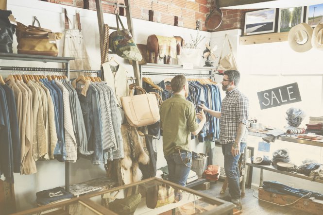 Retail employee using G Suite integration to help customer in clothing store