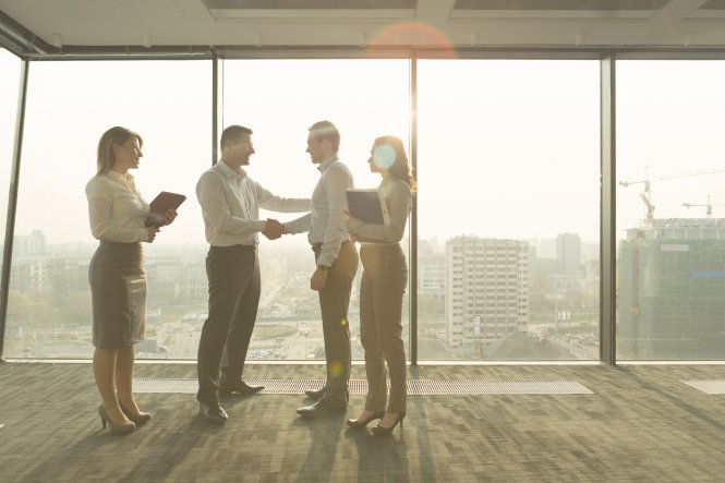 Person learning how to choose the right communications solution while shaking hands with provider