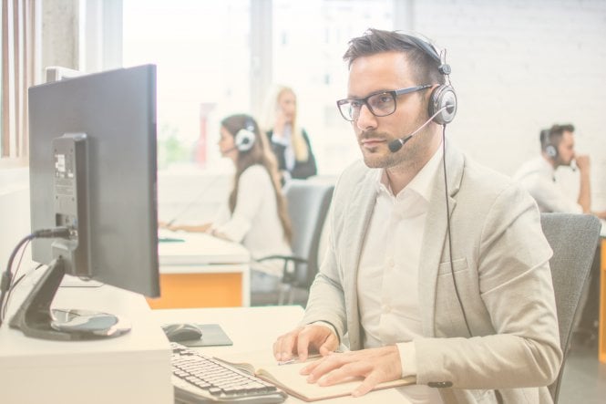 Employee using communication and productivity to help a customer via a desktop and headset
