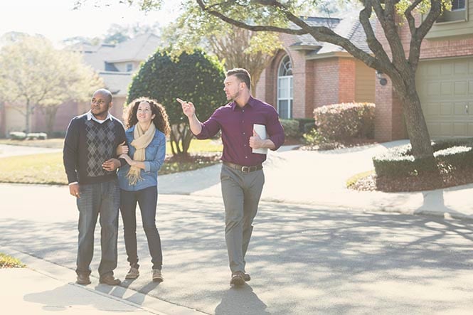 Real estate agent shows couple homes and uses the best small business video conferencing