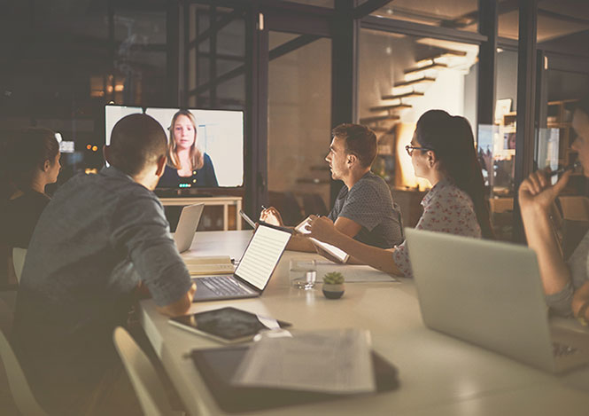 Team using desktop video conferencing solutions to talk with a remote employee