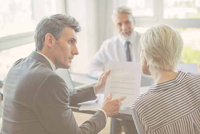 Insurance claims agent talking with client about how to increase productivity with cloud integration