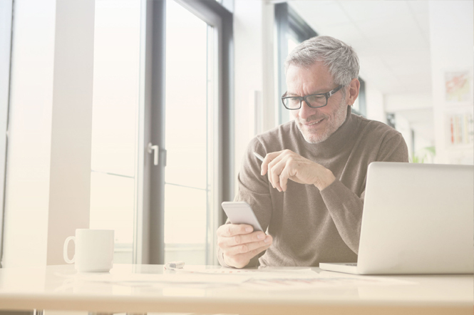 Business person using network bandwidth and an SD-WAN solution on laptop and smartphone