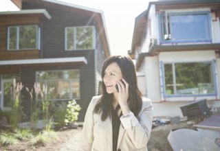 A woman engaging with a real estate chatbot on her phone.