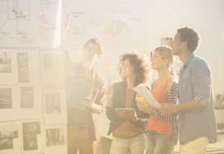 Young professionals asking "what is AI?" in a modern office