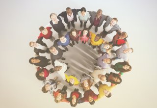 Students in a large group-hug, enjoying the benefits of a school communications plan