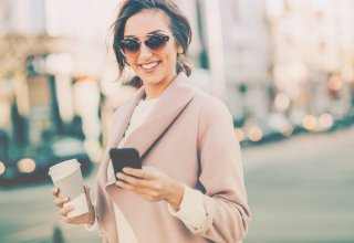 A woman uses two-way text messaging on her smartphone to contact her credit union