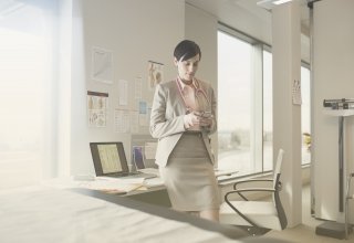 Doctor using telemedicine technology on smartphone in office to reach patient