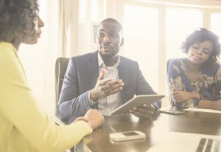 Vonage channel partner communicating UCaaS benefits to enterprise leaders via a tablet