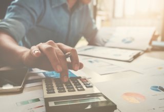 Accountant using mobile device and calculator to streamline communication