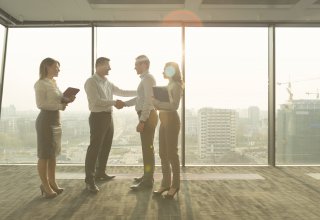 Person learning how to choose the right communications solution while shaking hands with provider
