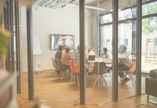 Group of employees using video conferencing infrastructure to talk with remote colleague