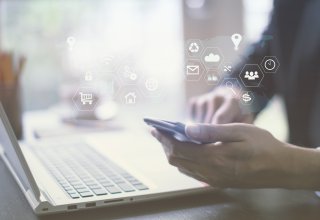 Person using smartphone with symbols representing artificial intelligence and unified communications
