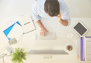 <p>Businessperson using new enterprise communications services through laptop and mobile device.</p>