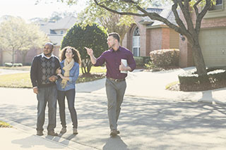 Real estate agent shows couple homes and uses the best small business video conferencing