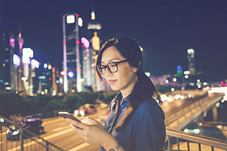 Traveler looking at app on phone via a hotel API integration