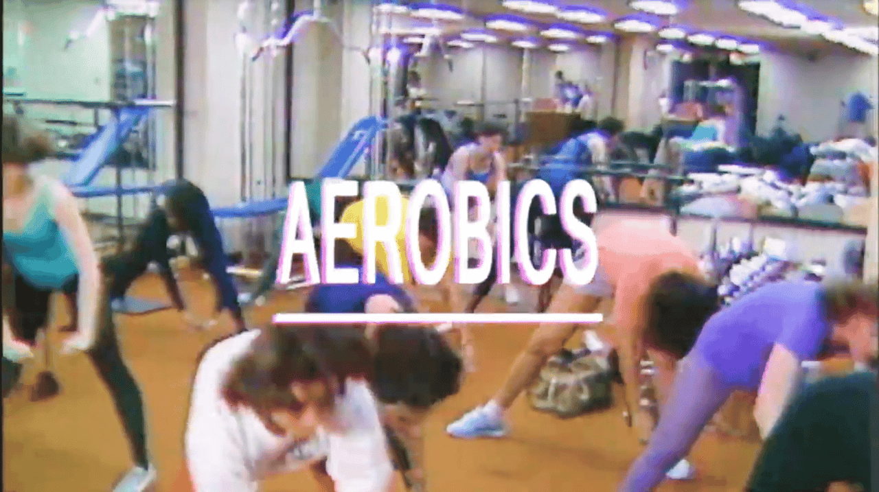 photo of 1980s aerobics studio with the word "aerobics" written across is