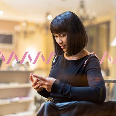 UC Collaboration Blog Header Photo of woman using her cell phone to work outside of an office setting