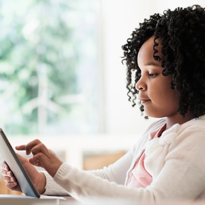 young girl using a tablet at home