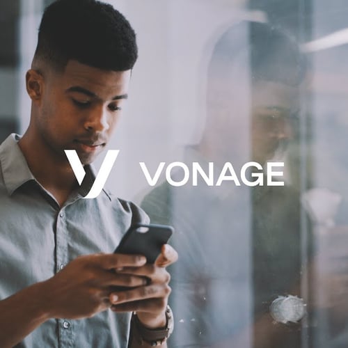 Young man looks at phone with Vonage logo superimposed 