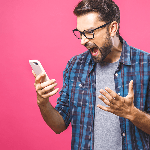 Man looking at cell phone angrily